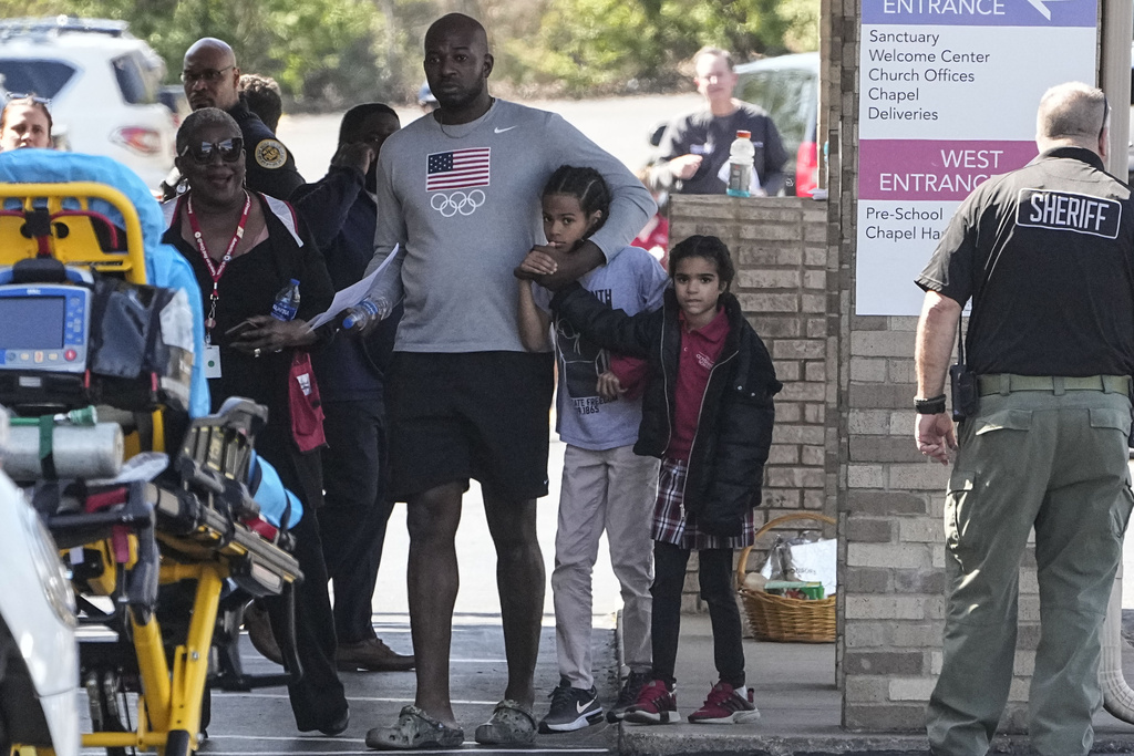 A family departs the reunification center at the Woodmont Baptist church after a school shooting
