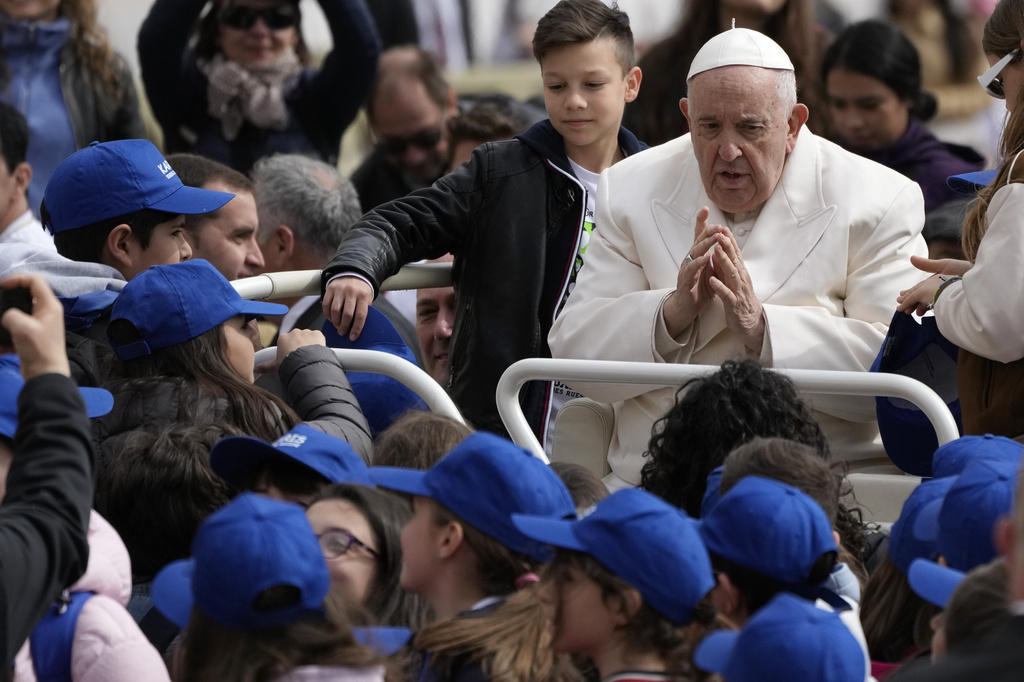 Pope Francis meets children at the end of his weekly general audience in St. Peter's Square, at the Vatican, Wednesday, March 29, 2023.