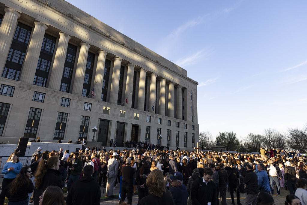 A crowd gathers outside the courthouse and City Hall for a vigil held for victims of The Covenant School shooting 