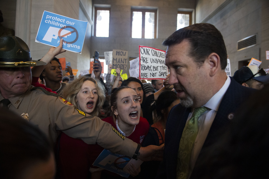 Addie Brue, 16 and Madeline Lederman, 17, shout "do something," with other protesters as Rep. Jeremy Faison, R-Cosby, Chairman of the House Republican Caucus, walks towards the House chamber doors