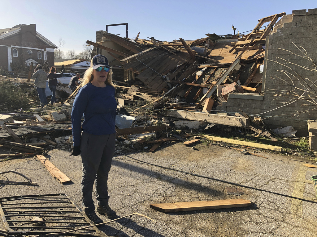 Heidi Jenkins, owner of Boulevard Salon, speaks with a reporter in front of her destroyed business in Wynne, Ark.,