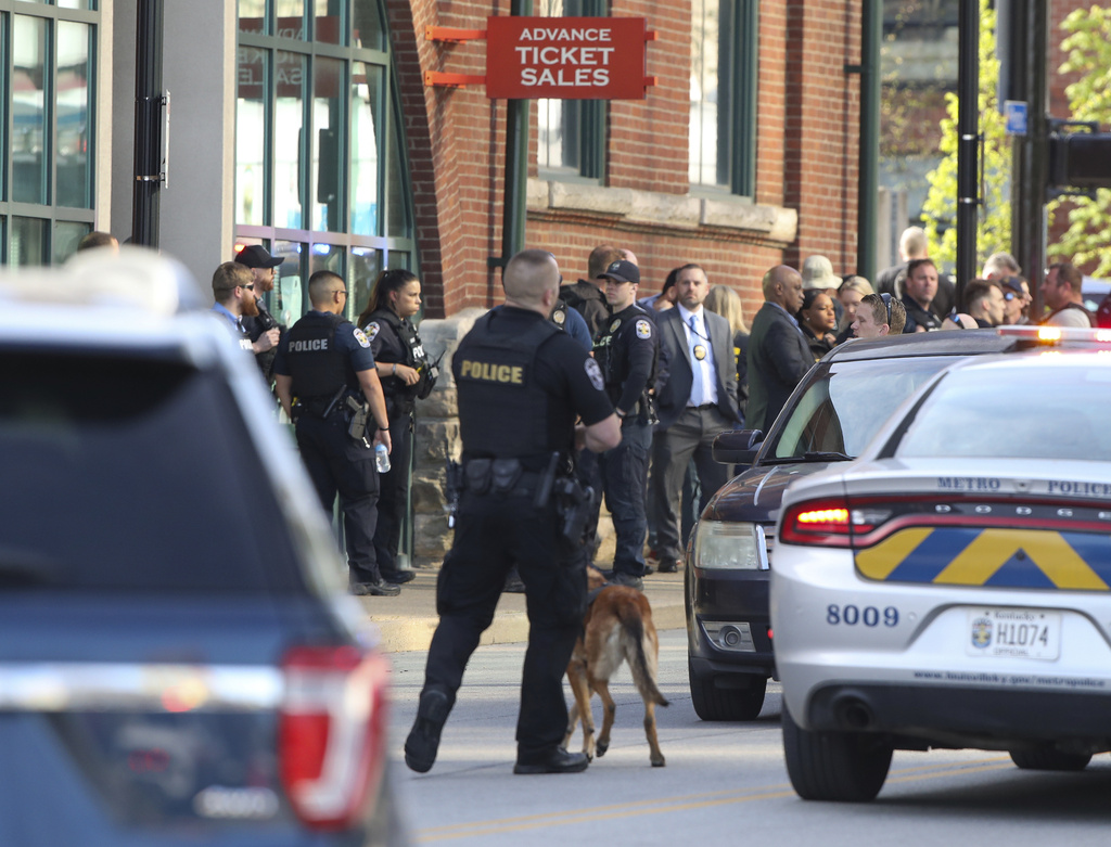 Multiple agencies arrive at a building after a shooting took place in Louisville, Ky.