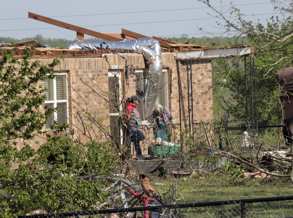 Damage to homes and businesses are seen in Cole, Okla.