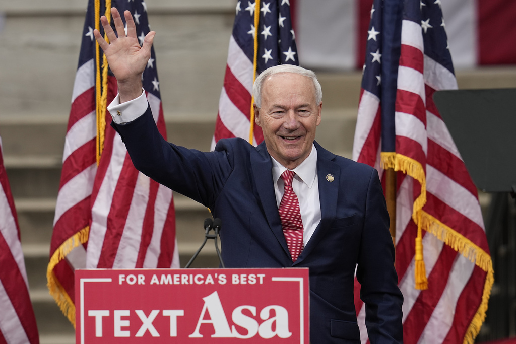 Former Arkansas Gov. Asa Hutchinson waves after formally announcing his Republican campaign for president