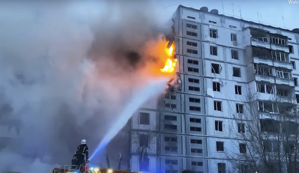 Firefighters work at an apartment building destroyed by a Russian attack in the town of Uman