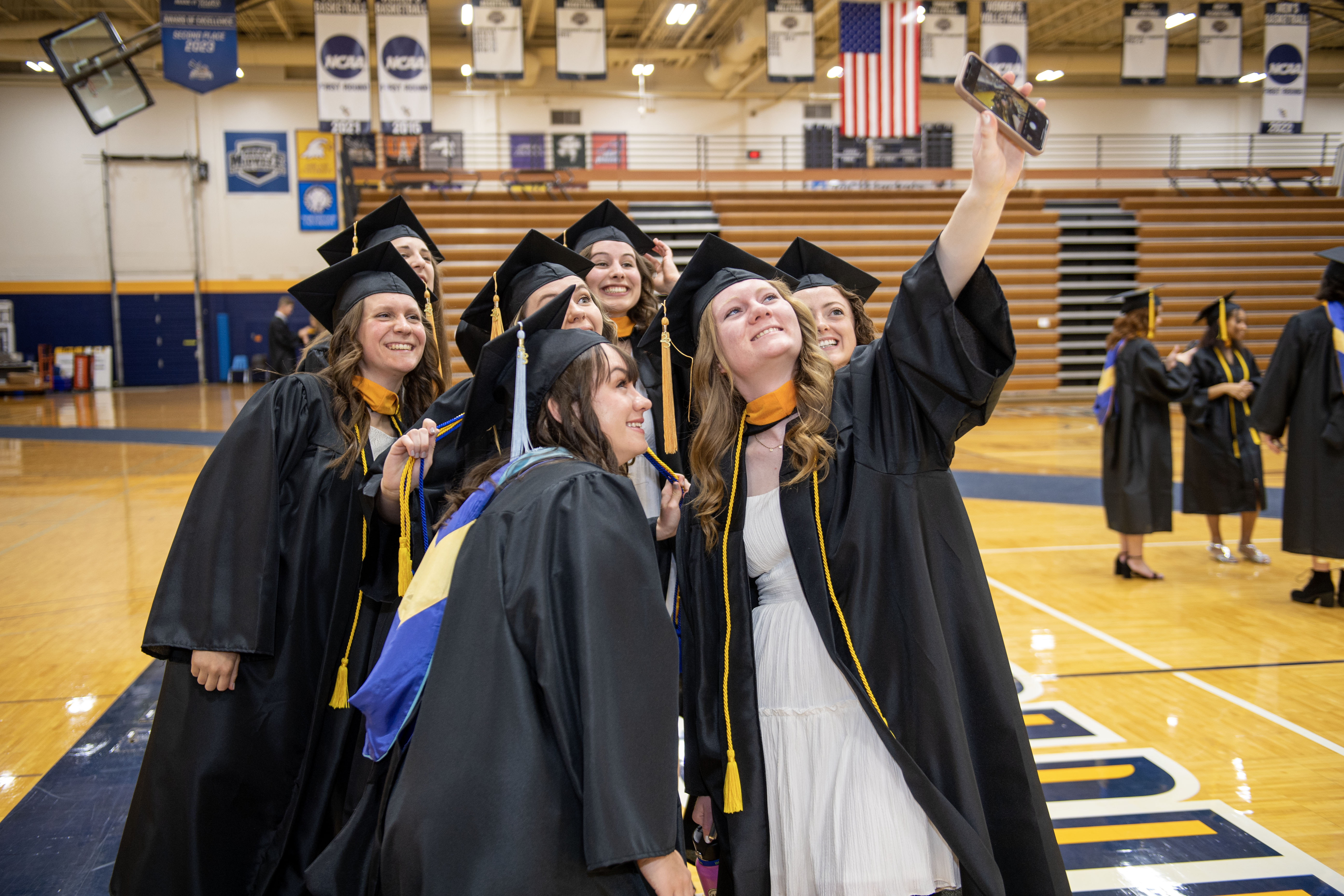 Rachel Walquist of Xenia, Ohio takes a selfie with some of her fellow graduates prior to the start of Cedarville University