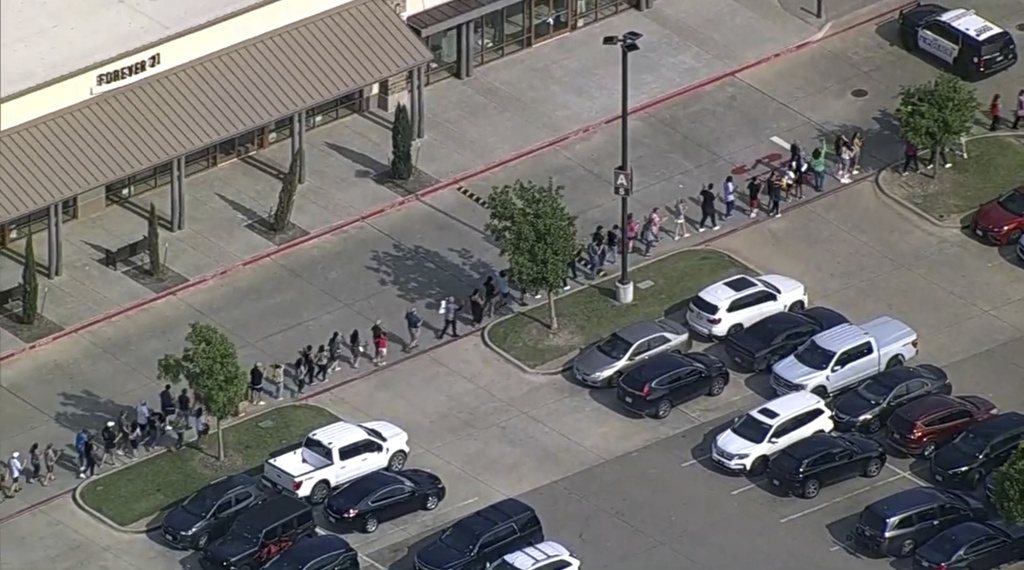 In this frame grab from video provided by WFAA, people are evacuated from Allen Premium Outlet, Saturday, May 6, 2023, in Allen, Texas.