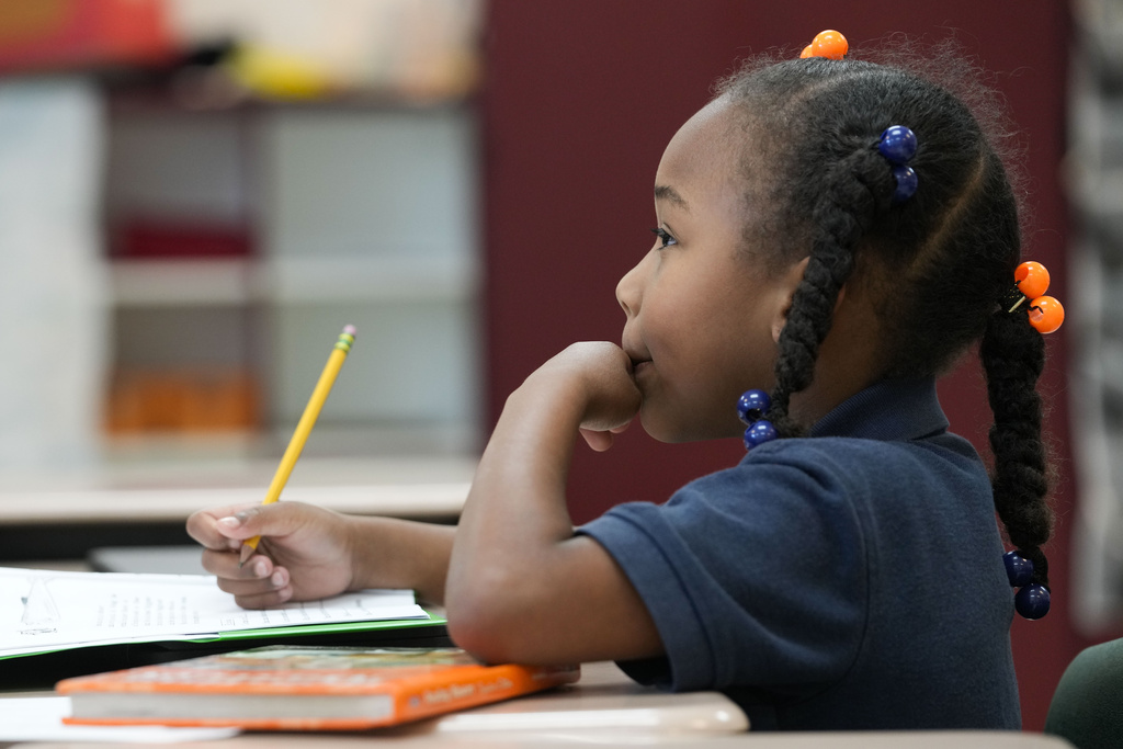 Second grader Demi Hill, 8, listens during class at Schaumburg Elementary