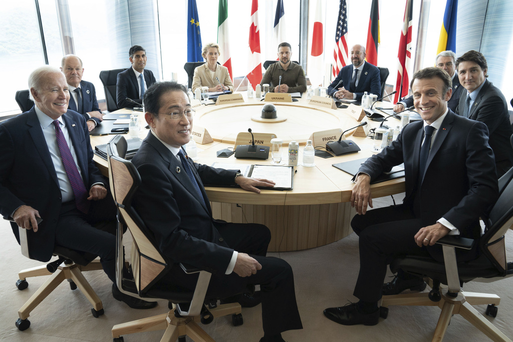 Ukrainian President Volodymyr Zelenskyy, center rear, joins G7 world leaders at a working session on the final day of the G7 Summit in Hiroshima, Japan