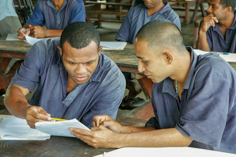 Two prisoners in Fiji participating in a course session for The Prisoner’s Journey
