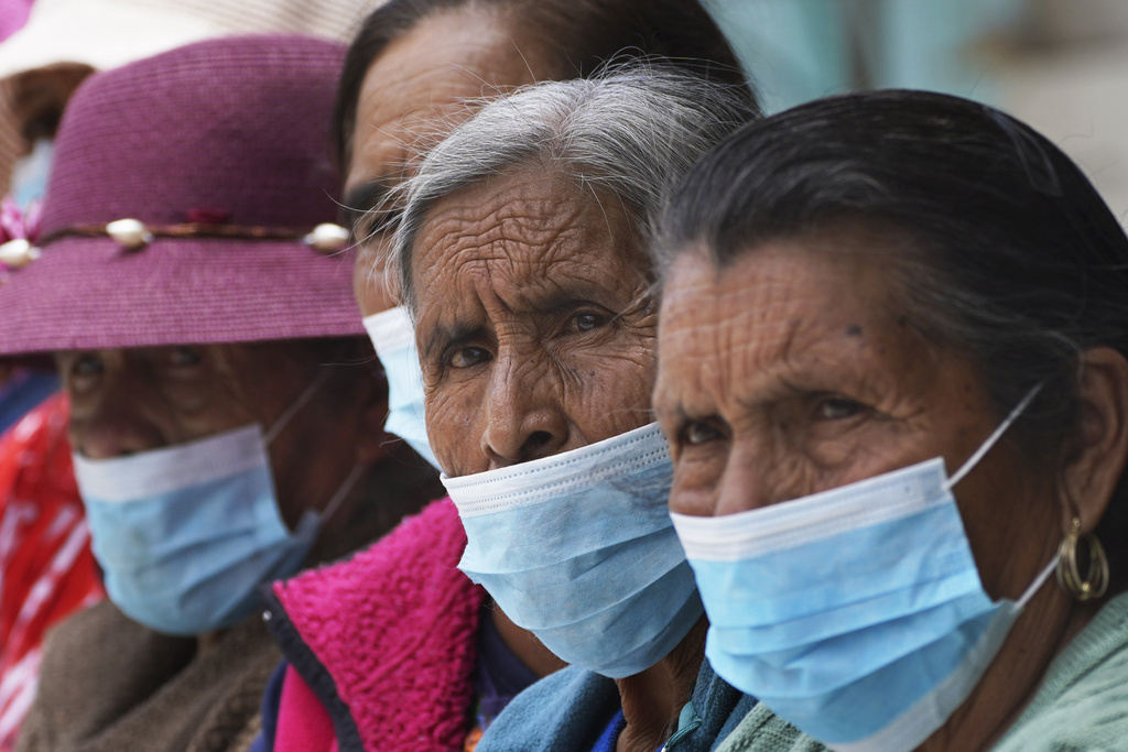 Women stand on an ash-covered street from the Popocatepetl volcano in Santiago Xalitzintla, Mexico