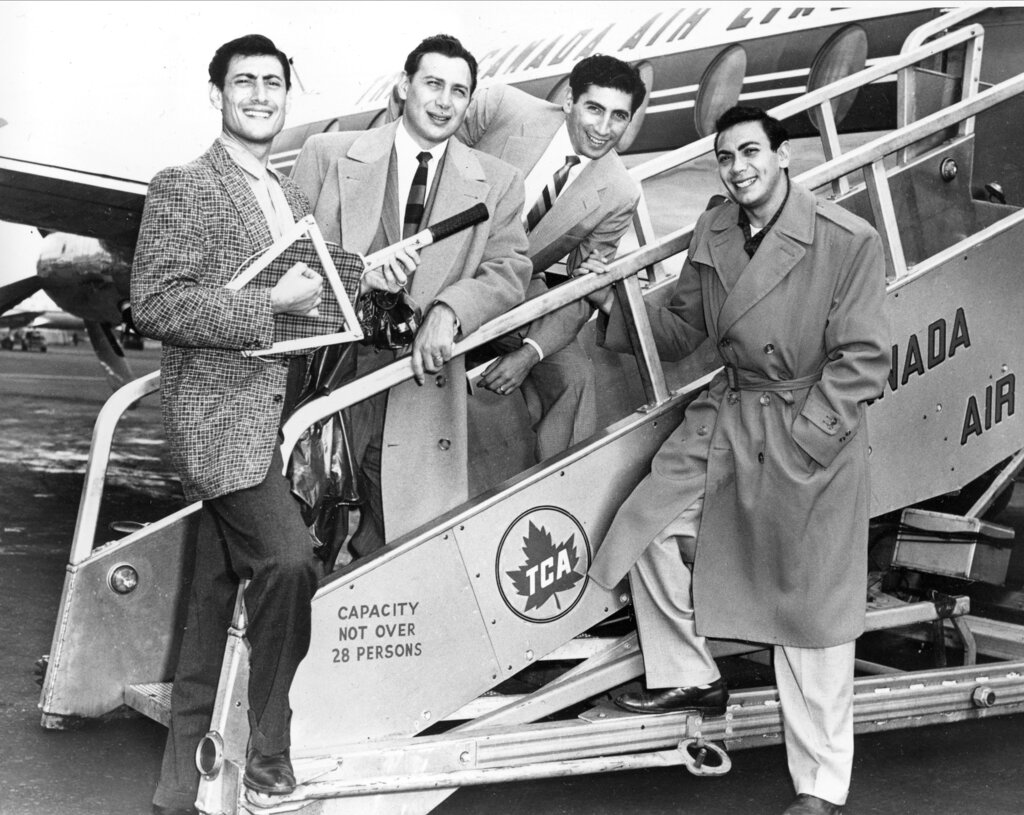 The Ames Brothers, from left, Vic, Joe, Gene and Ed, pose before boarding an airplane in New York City en route to Canada in Oct. 1955