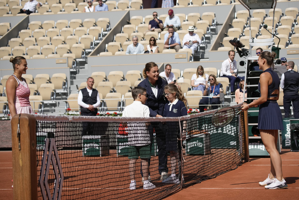 Aryna Sabalenka of Belarus, left, and Ukraine's Marta Kostyuk, right, did not greet each other and refused to pose for the traditional pre-match picture with the ball children in their first round match of the French Open tennis tournament at the Roland Garros stadium in Paris, Sunday, May 28, 2023.