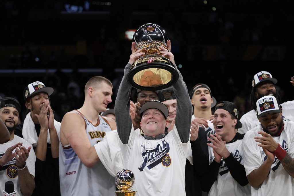 Denver Nuggets head coach Michael Malone holds the conference championship trophy
