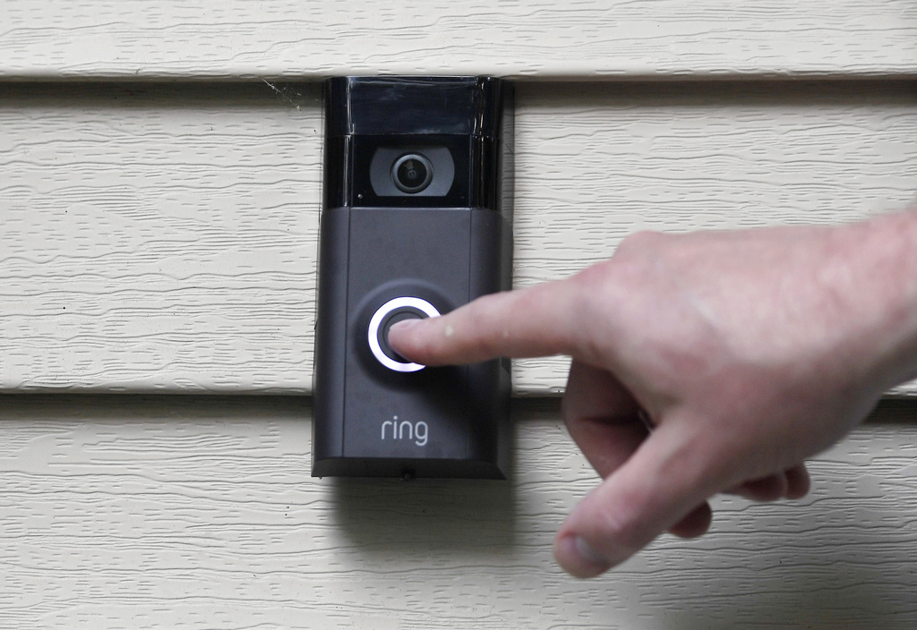 Ernie Field pushes the doorbell on his Ring doorbell camera at his home in Wolcott, Conn.
