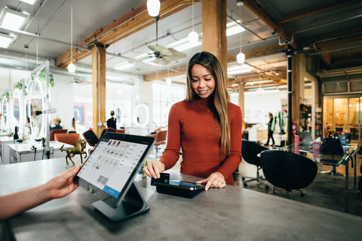 Woman using credit card for payment