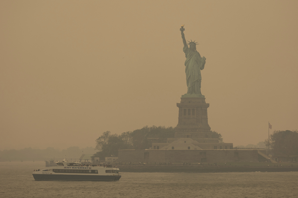 The Statue of Liberty, covered in a haze-filled sky, is photographed from the Staten Island Ferry, Wednesday, June 7, 2023, in New York.