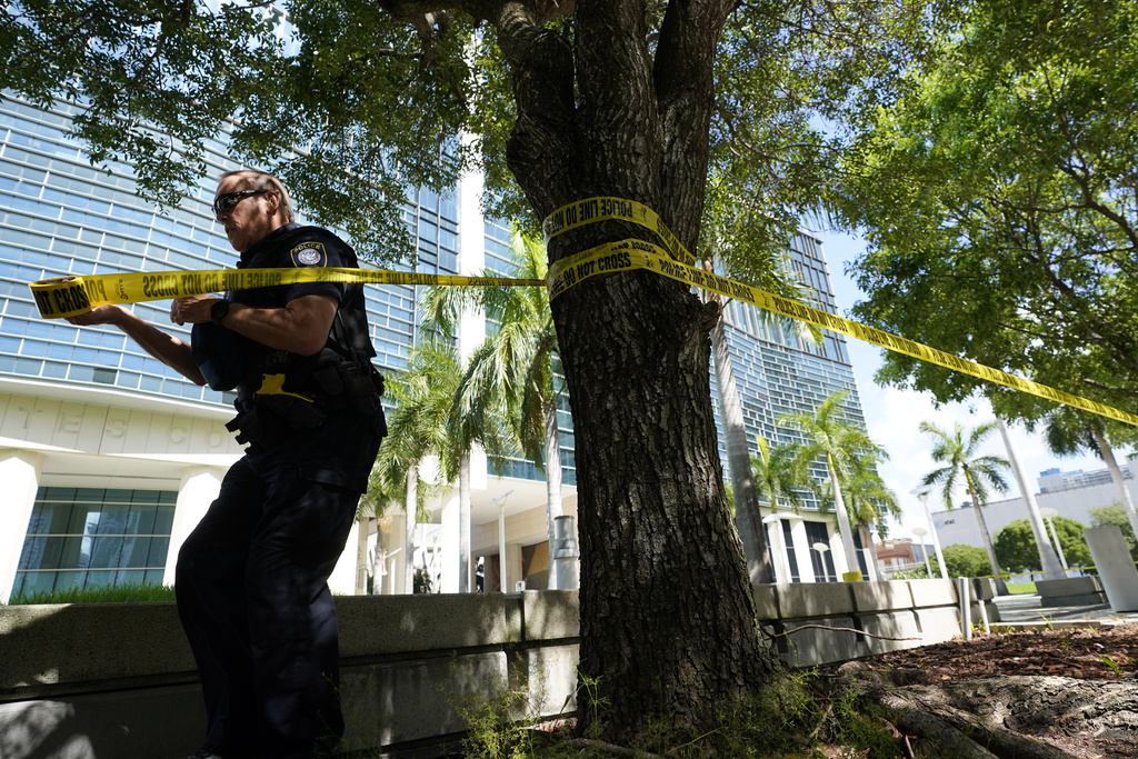 A Federal Protective Service Police officer cordons off an area outside the Wilkie D. Ferguson Jr. U.S. Courthouse in Miami