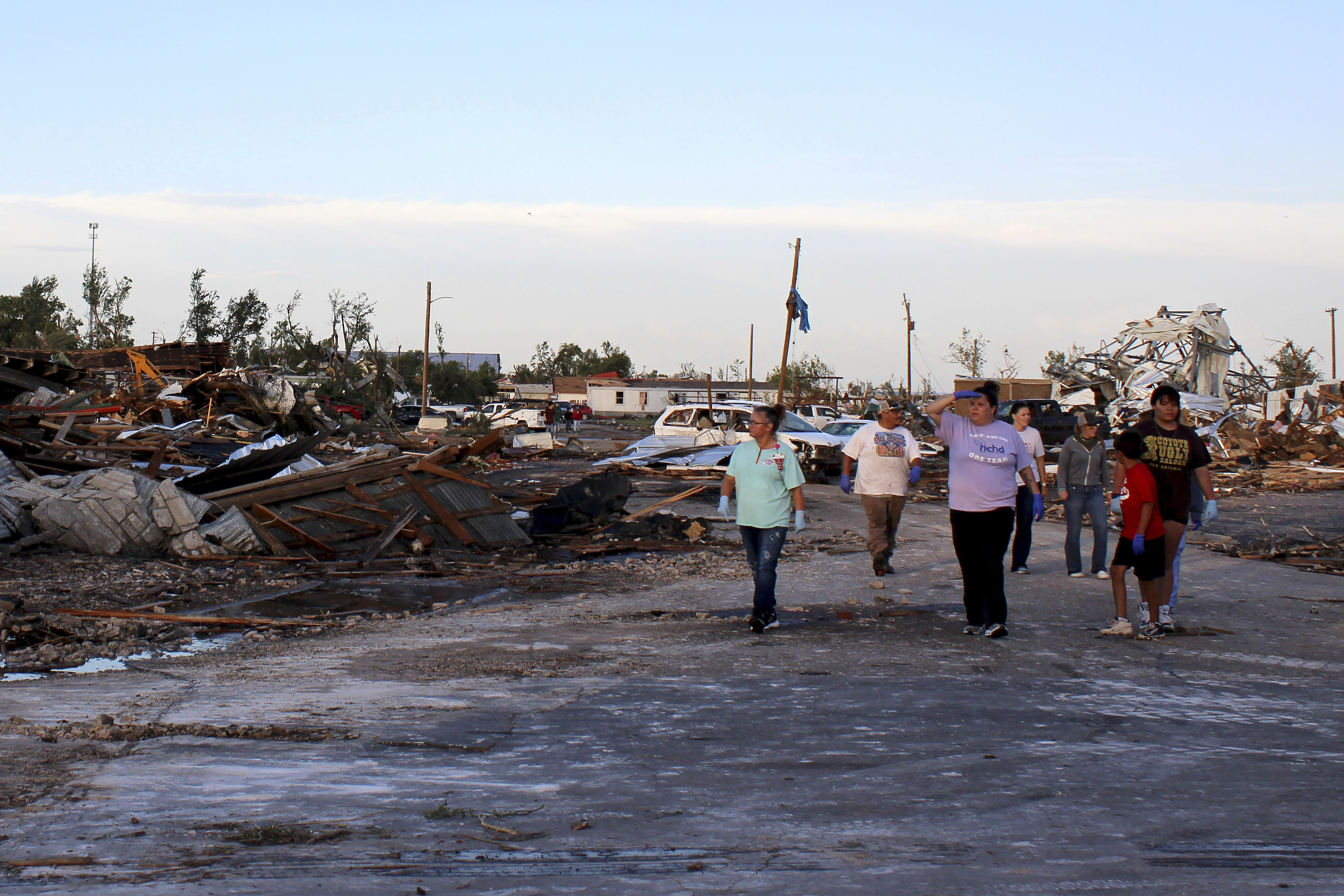 People survey tornado damage as cleanup efforts continue Friday, June 16, 2023, in Perryton, Texas