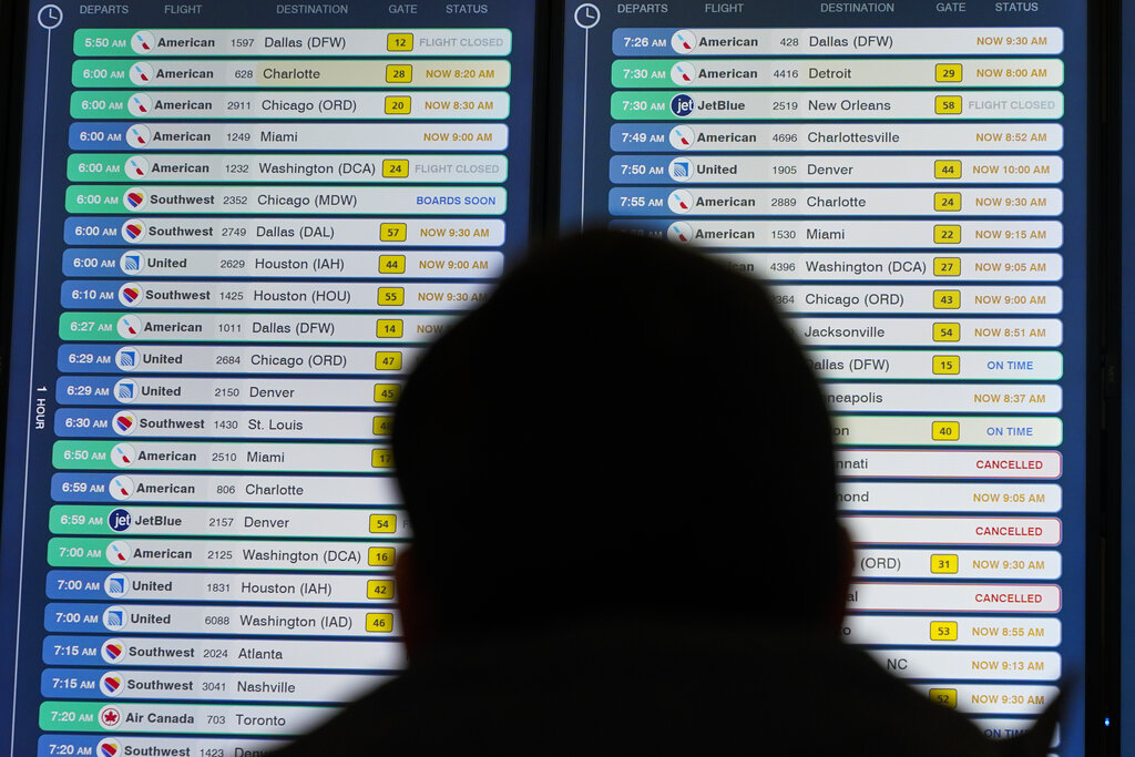 Display shows flights, many delayed, at LaGuardia Airport in New York