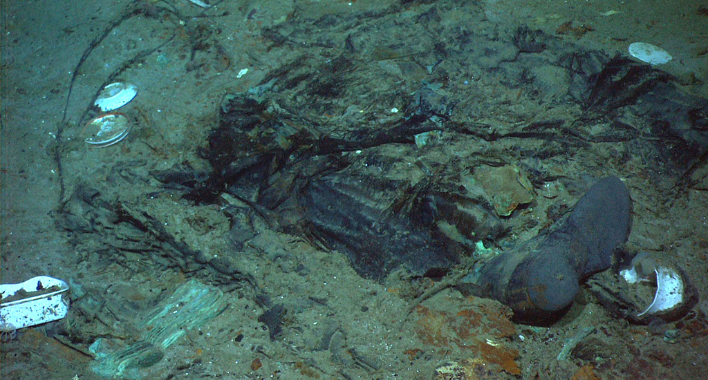 his 2004 photo provided by the Institute for Exploration, Center for Archaeological Oceanography/University of Rhode Island/NOAA Office of Ocean Exploration, shows the remains of a coat and boots in the mud on the sea bed near the Titanic