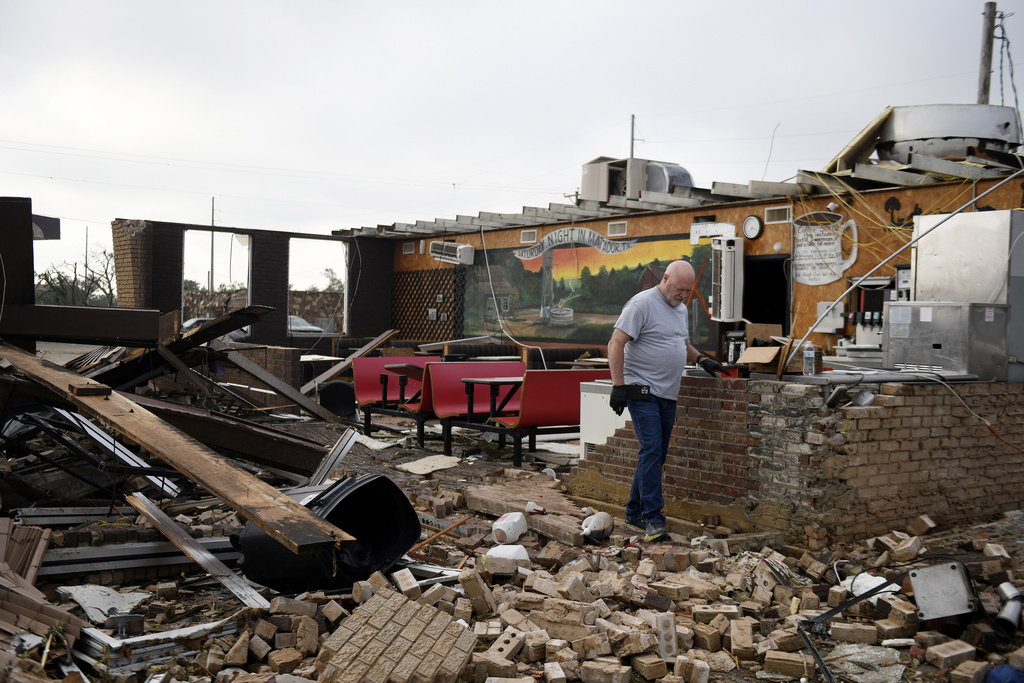 Pat Smith looks through his restaurant, Matador Diner, after a tornado in Matador, Texas