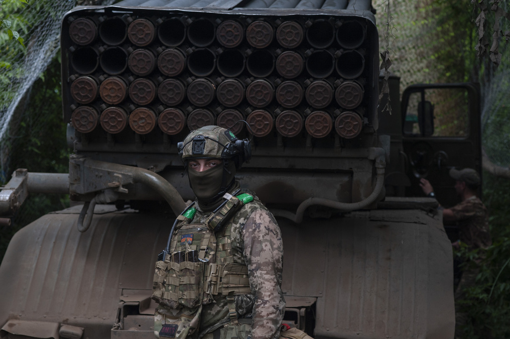 A Ukrainian soldier stands next to an MSLR BM-21 "Grad" at the frontline near Bakhmut
