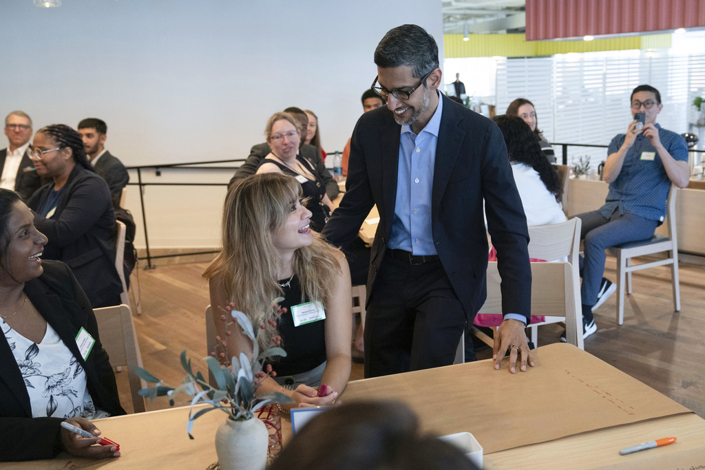 Google CEO Sundar Pichai greets college students during a workshop at the Google office in Washington