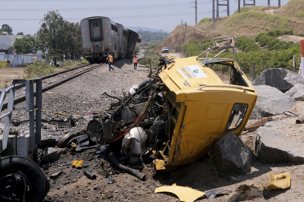 A destroyed truck lies next to a derailed Amtrak train in Moorpark, Calif.