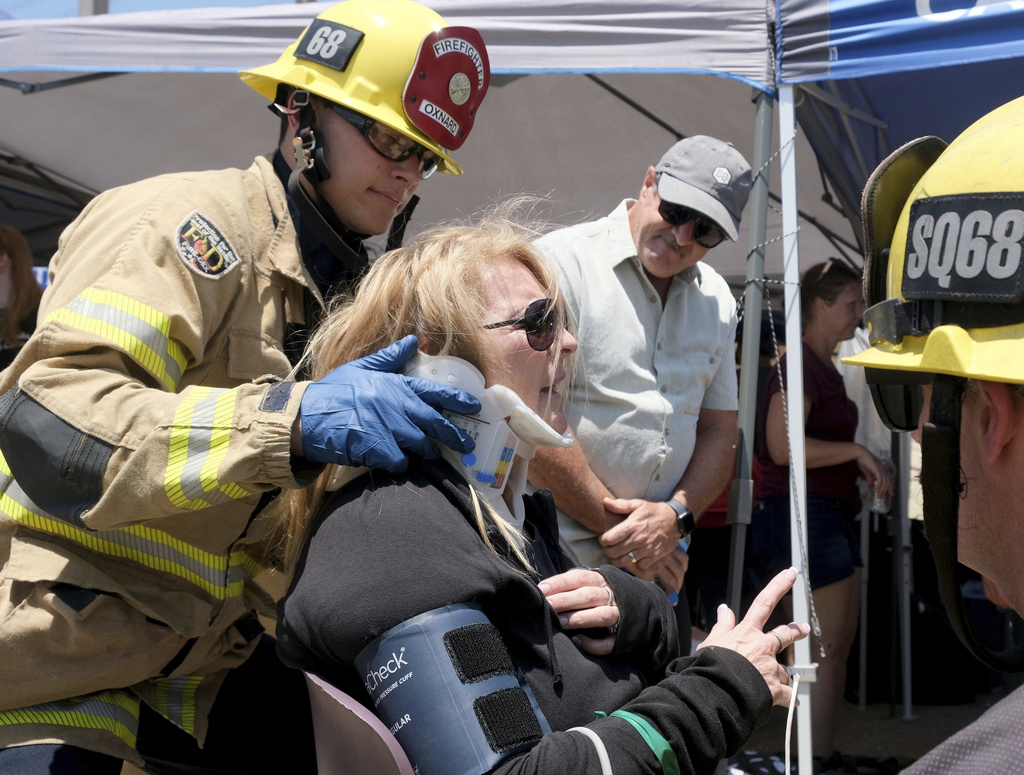 Trish Montanari, 60, from Florida, receives medical attention after their Amtrak train derailed in Moorpark, Calif.