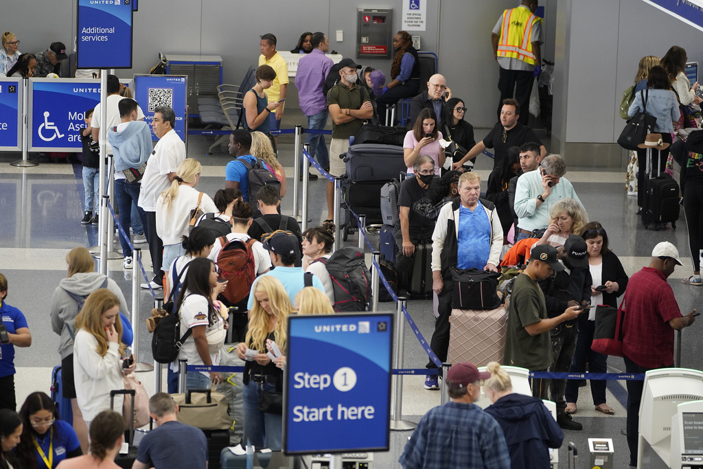 Travelers wait at the departure area check-in at the United Airlines terminal at Los Angeles International airport, Wednesday June 28, 2023, in Los Angeles.