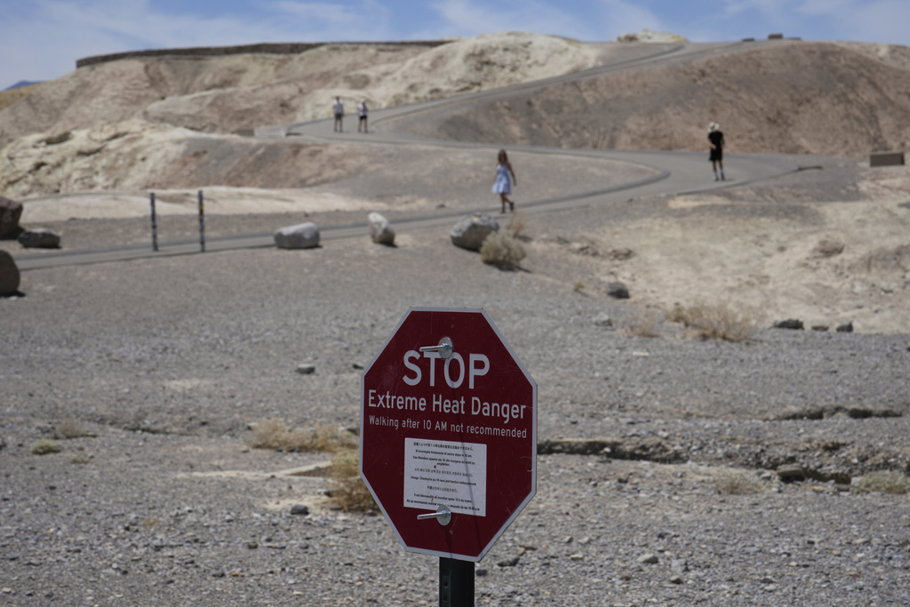 A sign warns of extreme heat danger  in Death Valley National Park, Calif. 