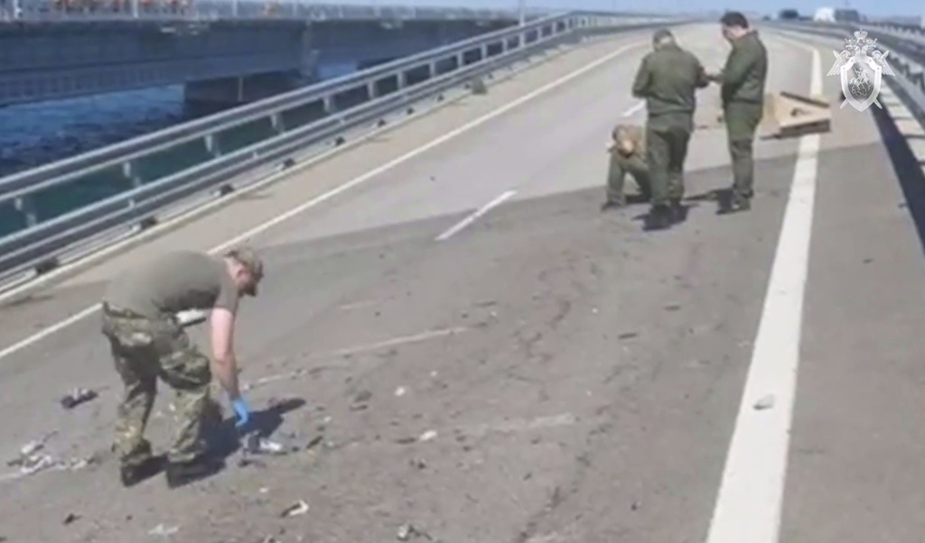 Investigators work at an automobile link of the Crimean Bridge connecting Russian mainland and Crimean peninsula 