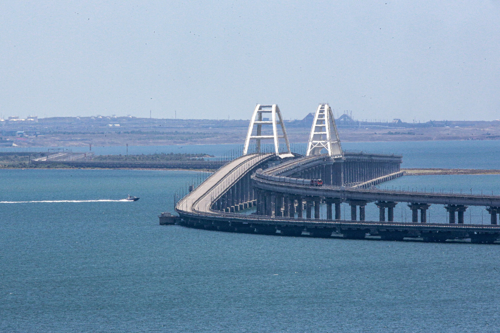 A freight train runs on rails of a railway link of the Crimean Bridge connecting Russian mainland and Crimean peninsula over the Kerch Strait not far from Kerch, Crimea