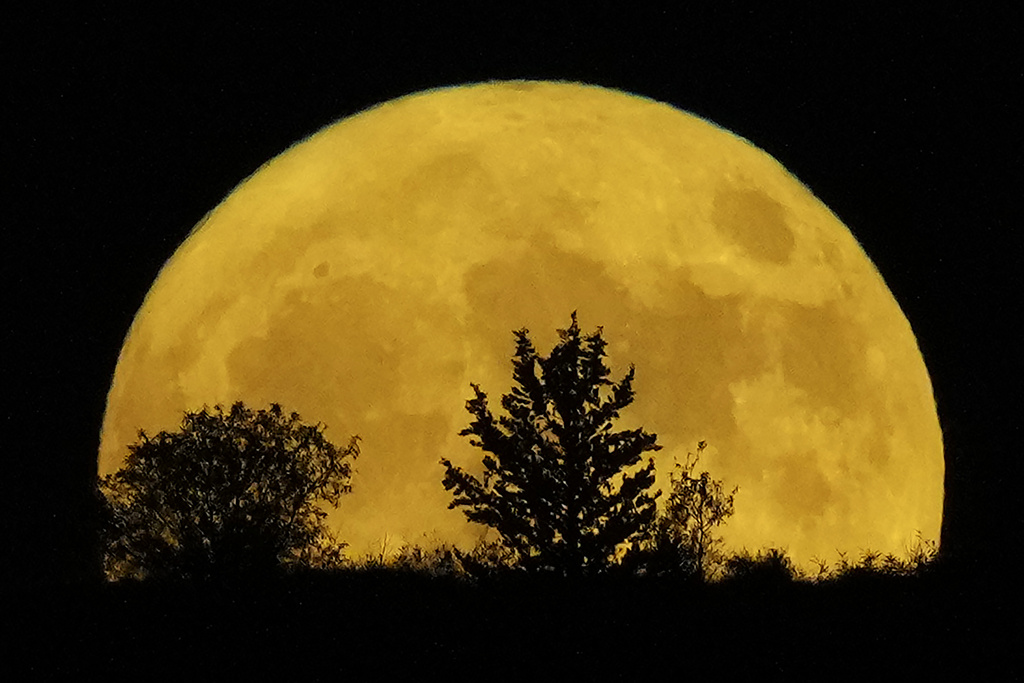 The supermoon rises behind a hill at Pera Chorio Nisou, outskirts of Nicosia, Cyprus