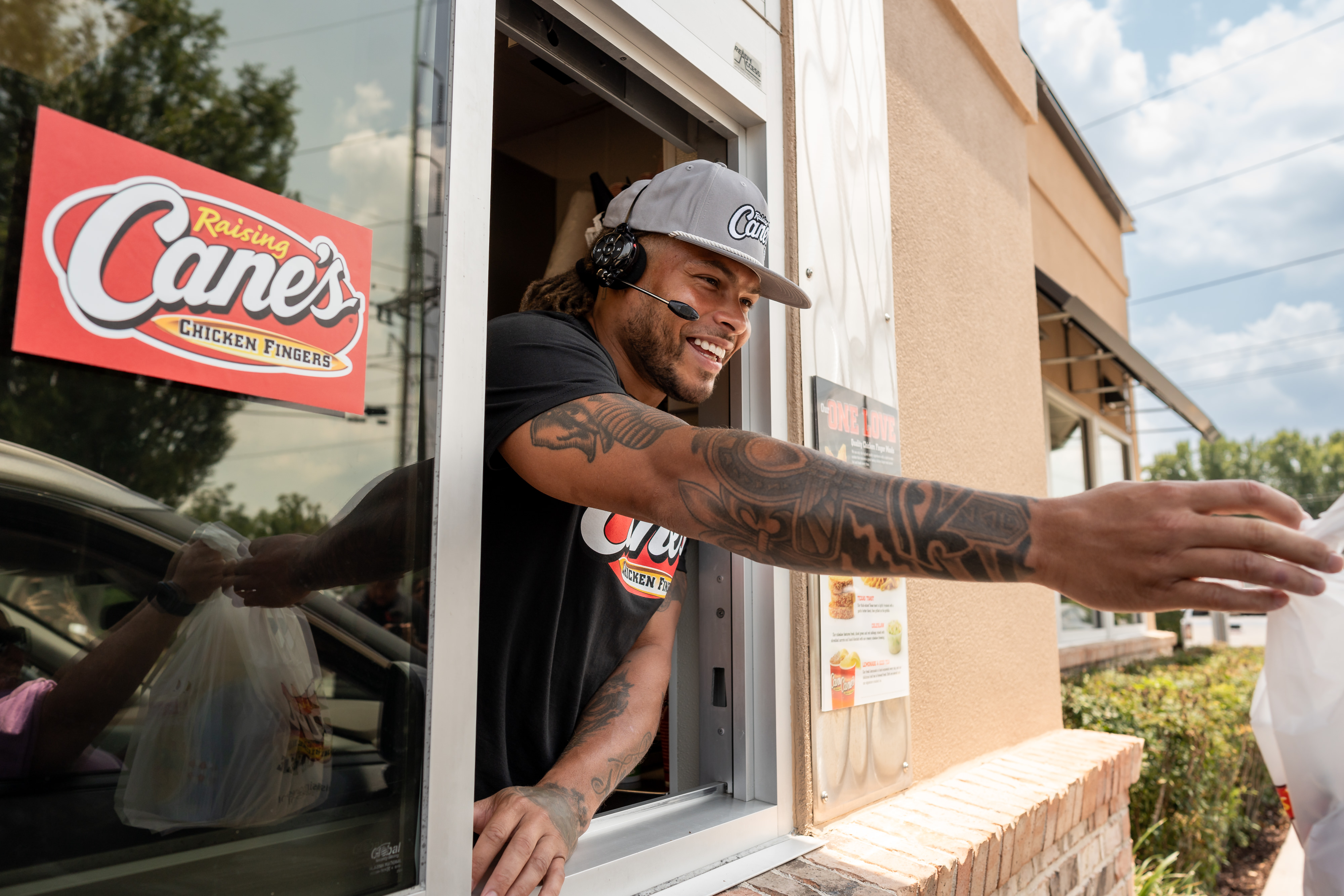 Saints safety Tyrann Mathieu works at Raising Cane's to raise