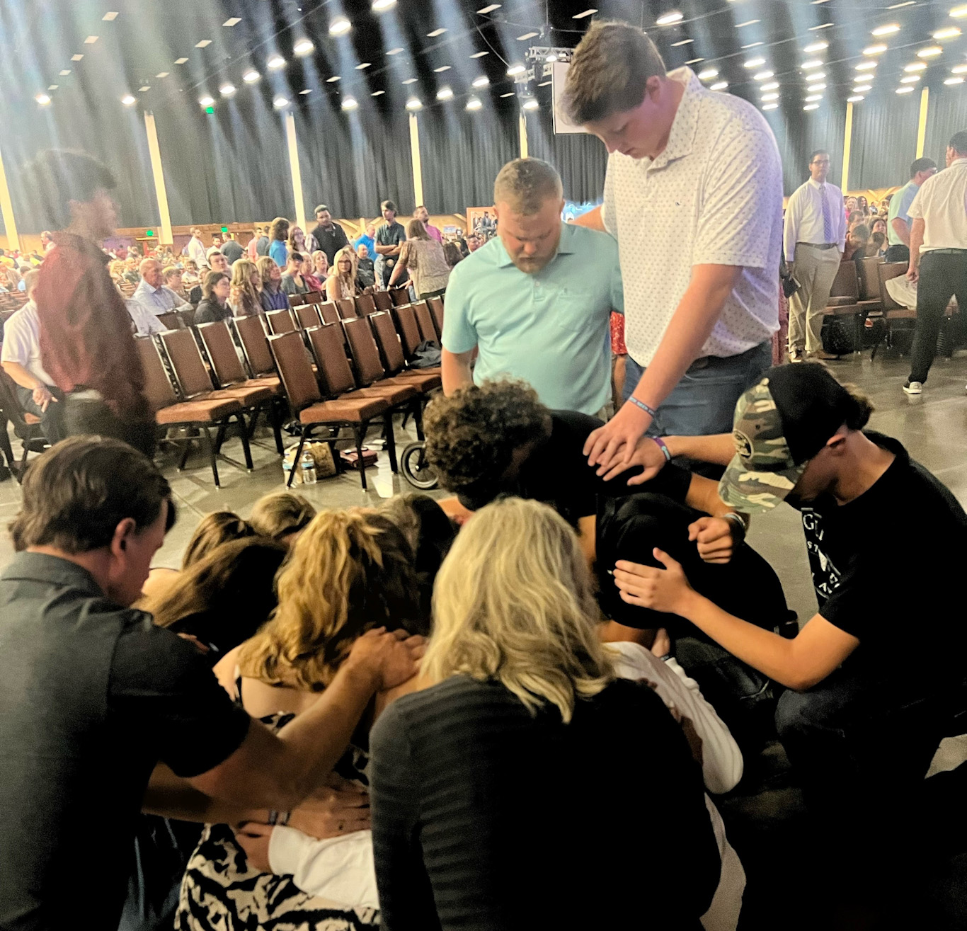 Young people pray for one another at youth event