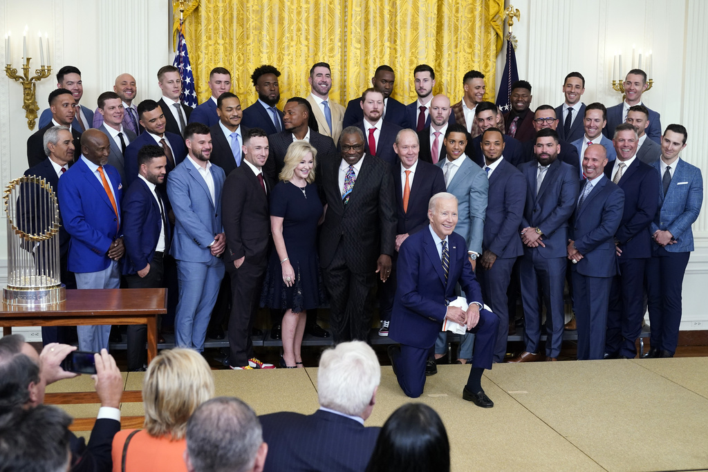 President Joe Biden poses for a photo during an event celebrating the 2022 World Series champion Houston Astros baseball team in the East Room of the White House