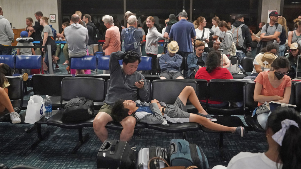 People gather at the Kahului Airport while waiting for flights 