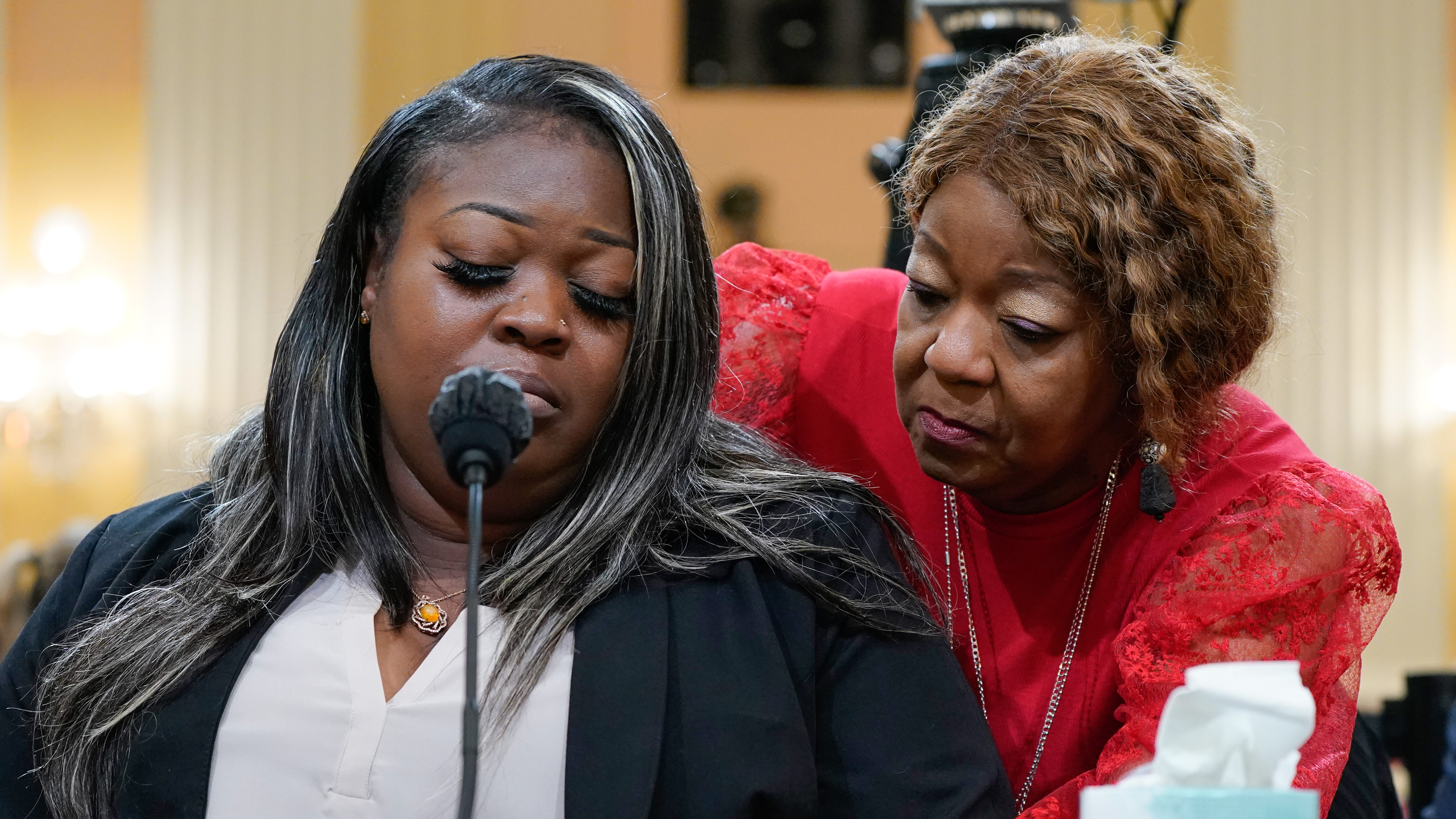 Mother and Daughter sitting in the Jan. 6th hearing in front of a microphone.