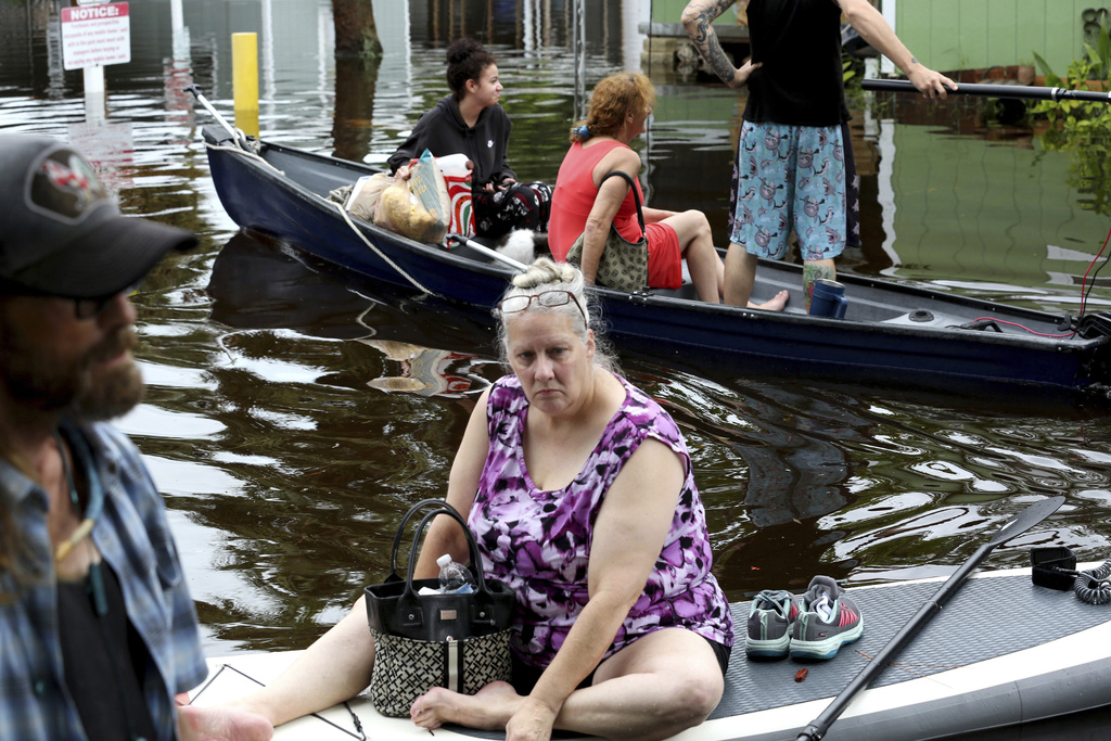 Residents of Twin City Mobile Home Park, a manufactured home community in flood zone A, navigate through the neighborhood in high waters, 