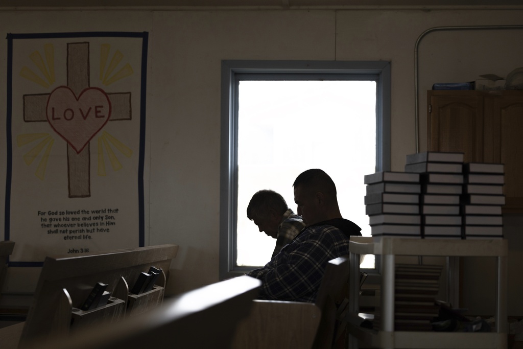 Churchgoers bow their heads during prayer inside the Akiachak Moravian Church in Akiachak, Alaska. "Not even half a year, and people don