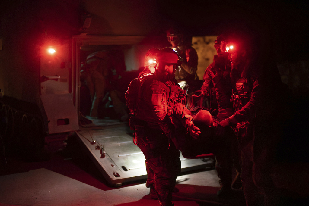 Ukrainian paramedics from 3rd Assault brigade carry on a stretcher their wounded comrade