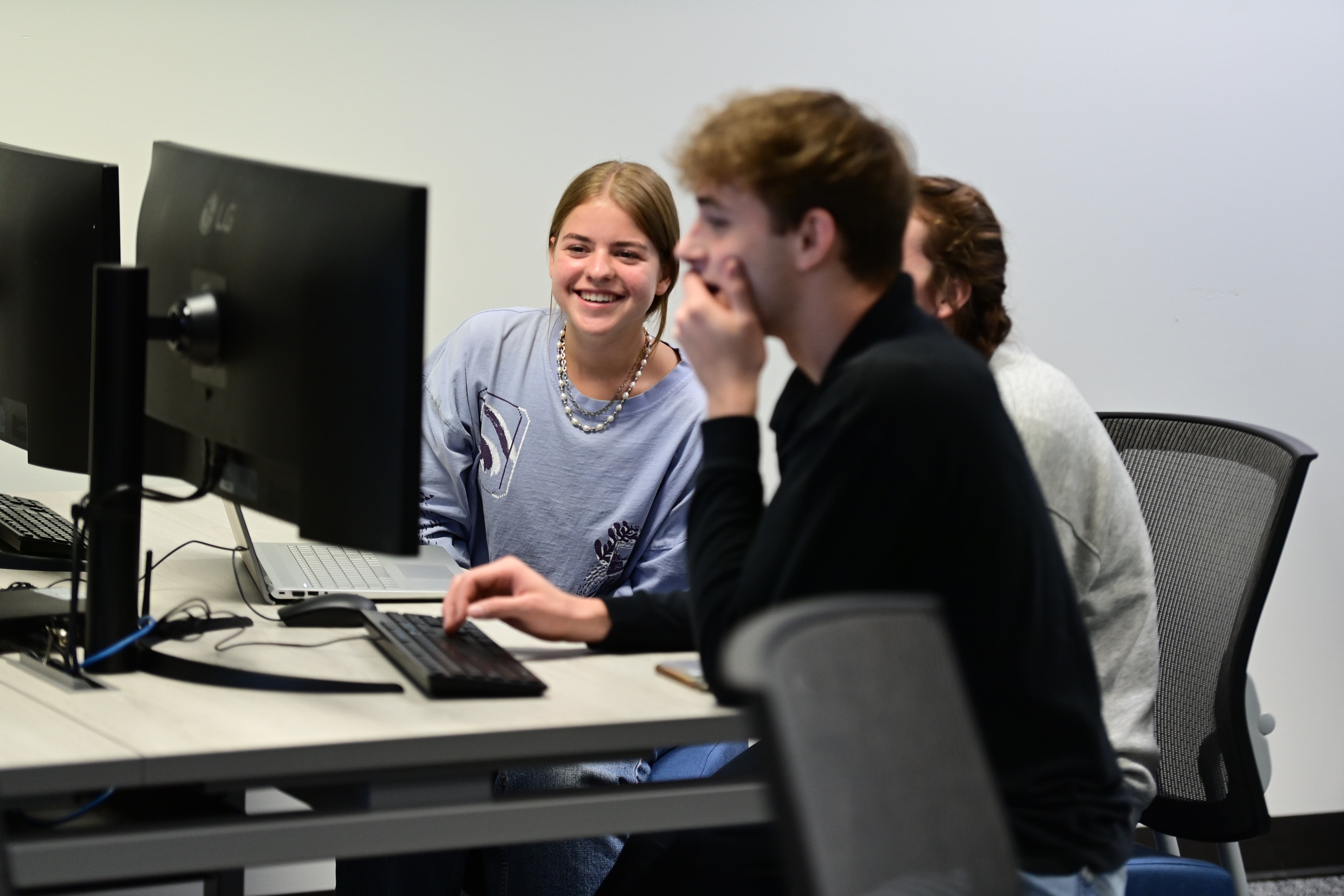 Students use the new larger monitors for their projects