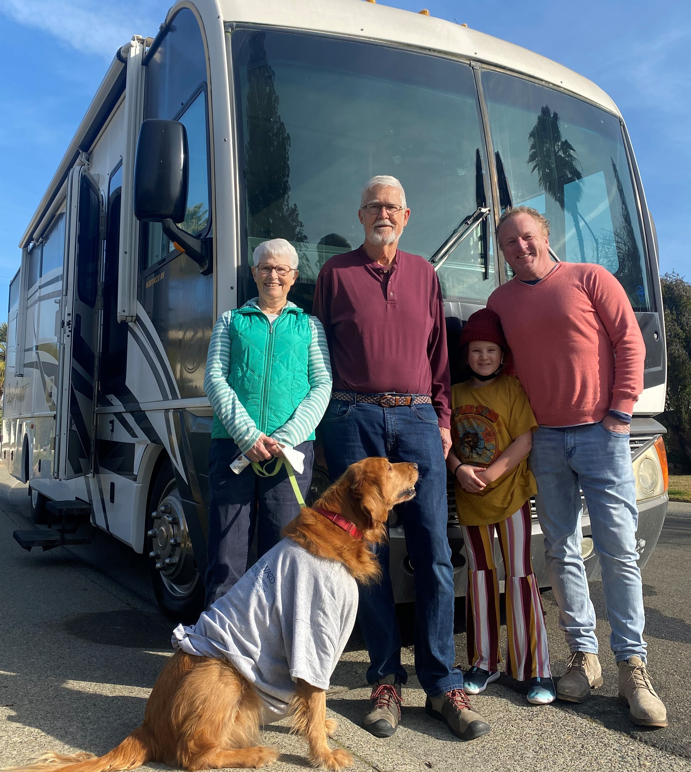 Elderly couple and dog with Luna and Woody in front of an RV