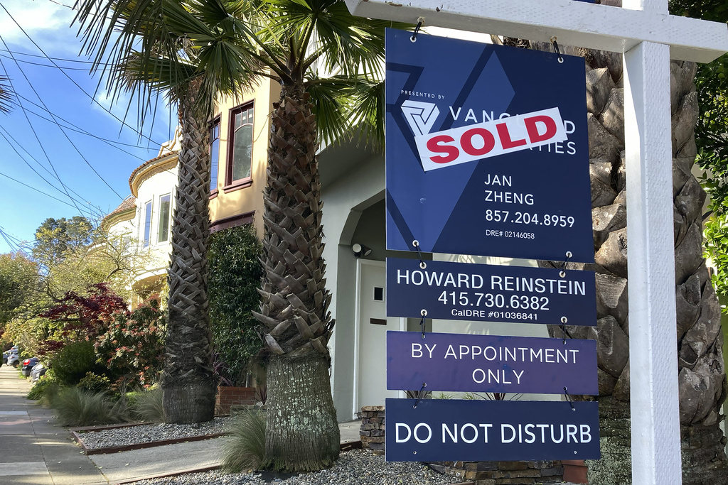 A notice indicating that a home has been sold appears on a sign in residential section of San Francisco, Friday, April 21, 2023.
