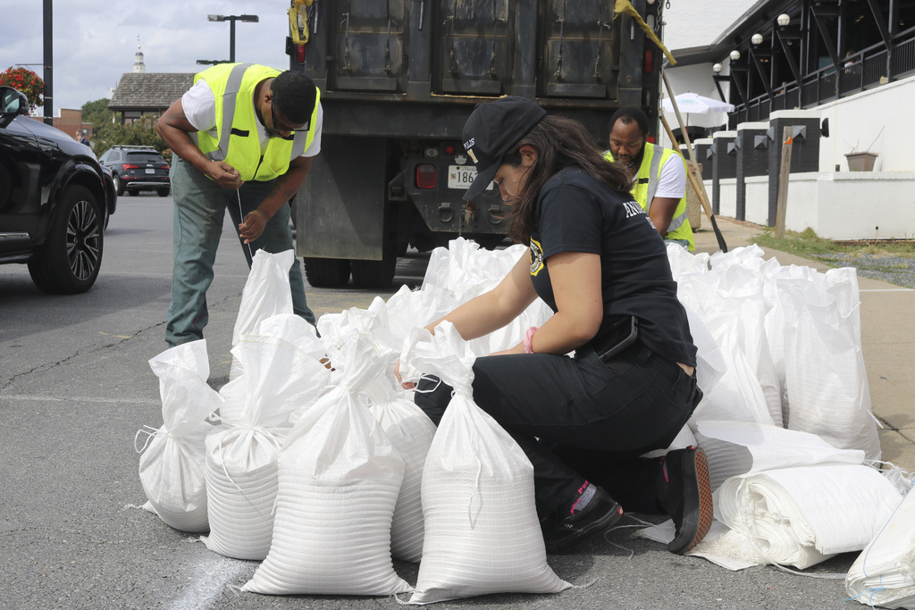 Nicole Torres, a spokeswoman for the Office of Emergency Management for the city of Annapolis, Md., ties a sandbag 