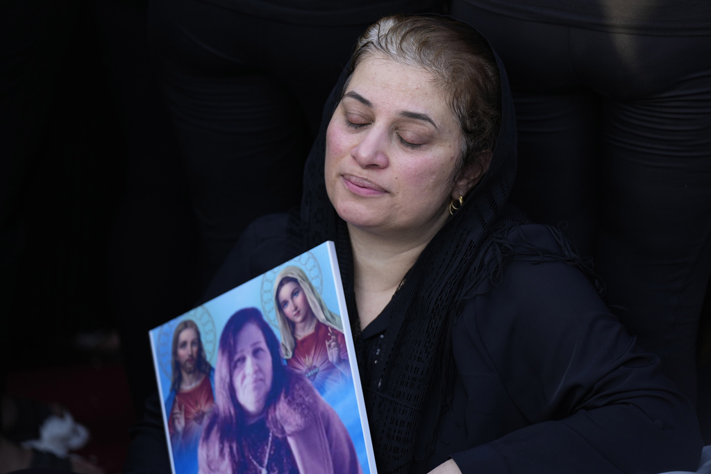 Friends and relatives attend the funeral of people who died in a fire during a wedding ceremony in Hamdaniya, Iraq