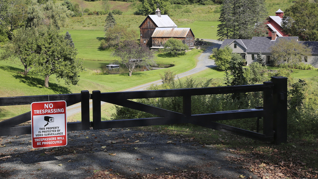 A no-trespassing sign hangs on a gate outside a private property in Pomfret, Vt.