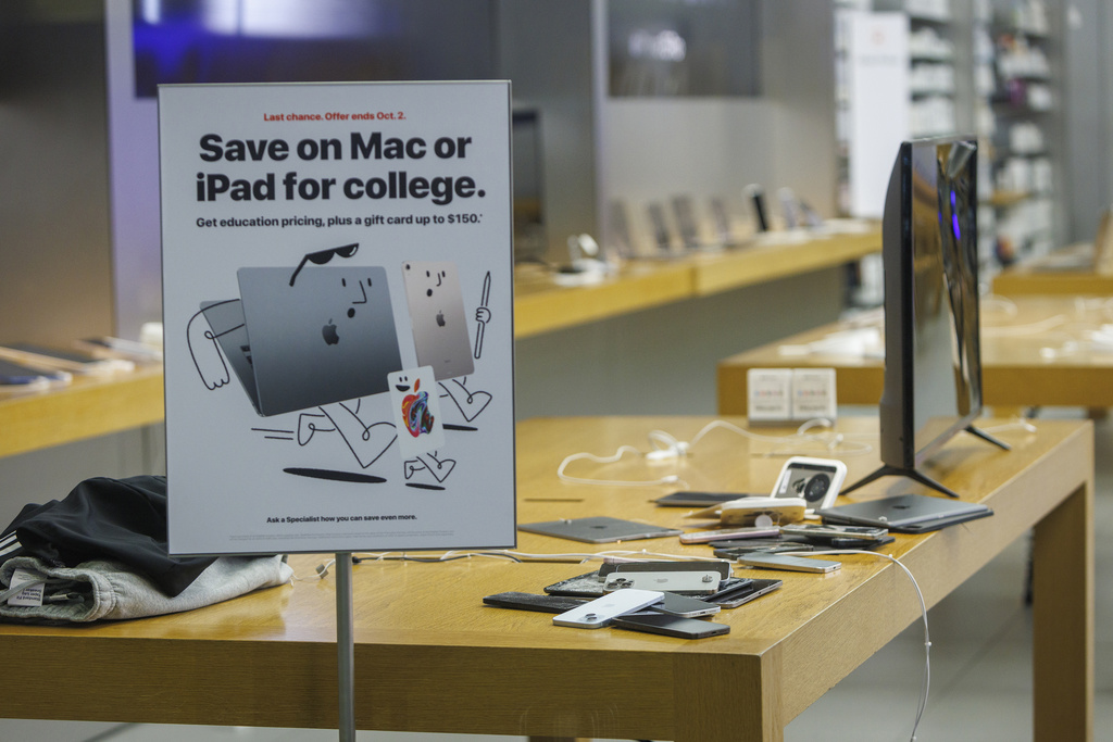 iPhones sit on the counter of a damaged Apple Store